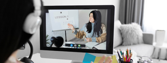 The image of a student attending an online class illustrates E-Learning Portal. 