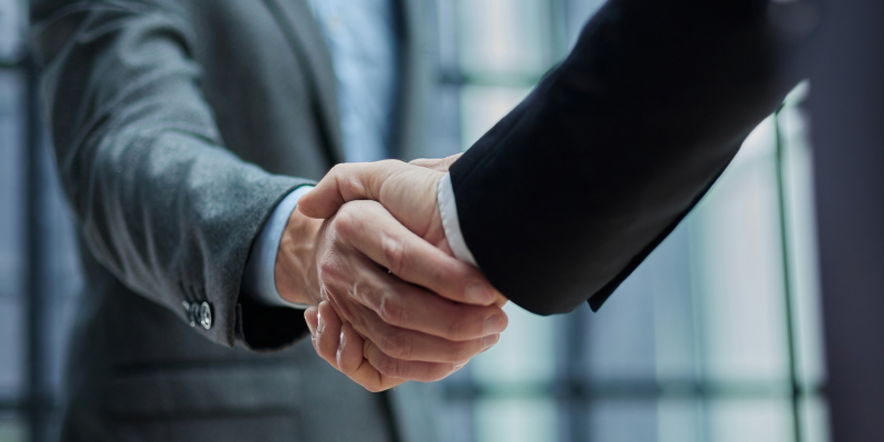 Businessmen making handshake for merger and acquisition.
